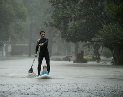 Alexendre Jourge uses evacuates Ethan Colman, 4, from a neighborhood in west Houston inundated by floodwaters from Tropical Storm Harvey on Monday, Aug. 28, 2017, in Houston, Texas. (AP Photo/Charlie Riedel)